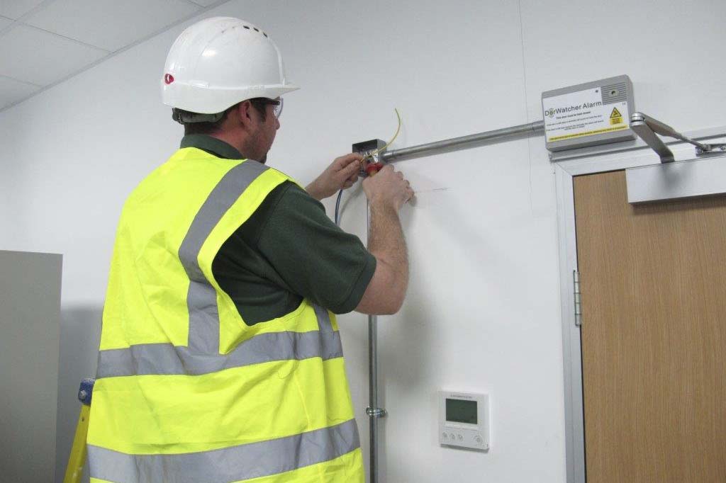 Man installing electrical cables into conduit