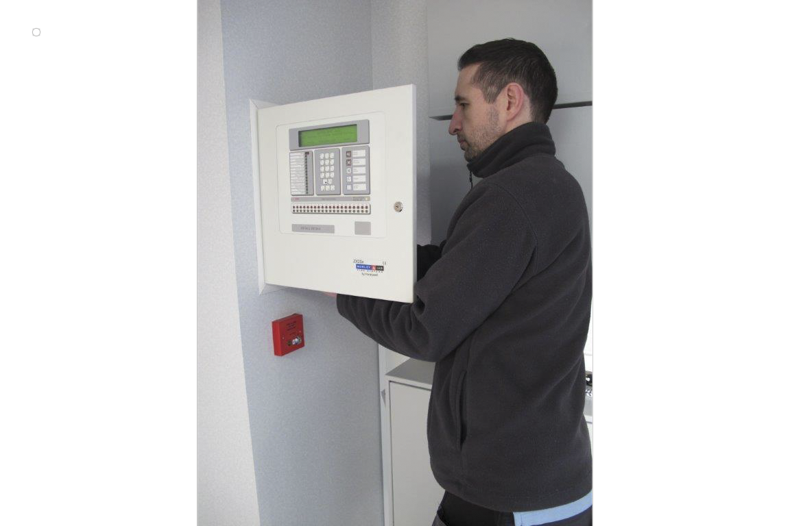 Man testing a fire alarm system